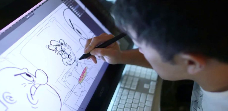 A Person Drawing A Cartoon Image In His Laptop.